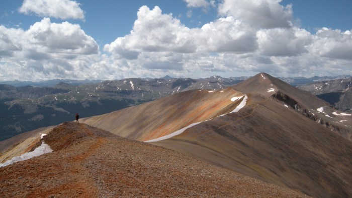 Joe traversing the saddle with Sunshine in the distance