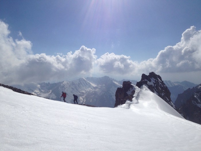 Chris and Bjorn departing from the summit of Panfilov onto the glacier
